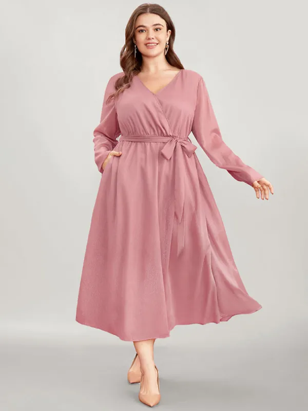 Solid Pocket Belted Surplice Neck Midi Dress sold by Bloomchic