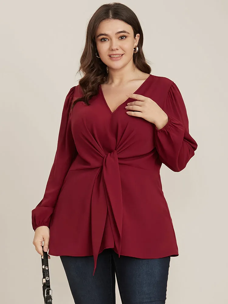 Solid V Neck Lantern Sleeve Knotted Front Blouse sold by Bloomchic