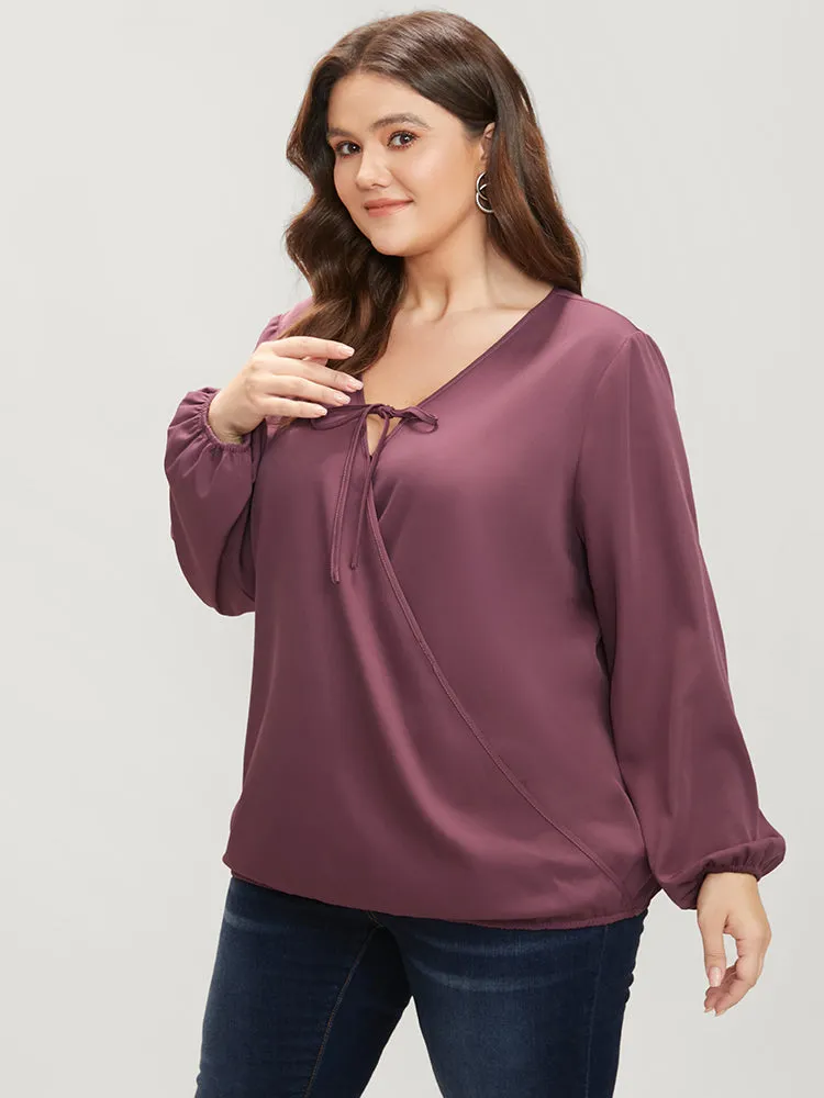 Solid Lantern Sleeve Tie Neck Wrap Blouse sold by Bloomchic