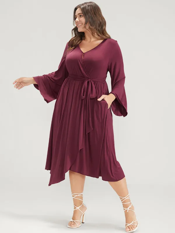 Solid Wrap Knotted Front Pocket Bell Sleeve Asymmetrical Hem Dress sold by Bloomchic