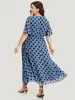 Polka Dot Two Tone Pocket Surplice Neck Dress sold by Bloomchic