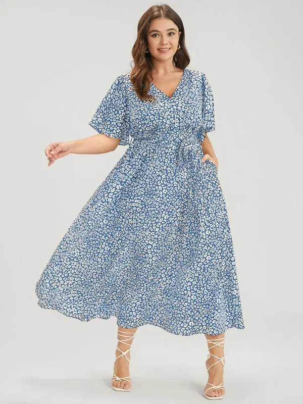 Floral Knotted Pocket Flutter Button Wrap Dress sold by Bloomchic