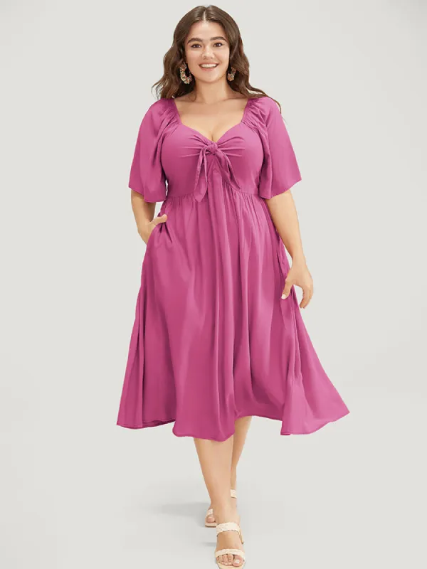 Solid V Neck Ruched Knotted Pocket Ruffle Hem Dress sold by Bloomchic