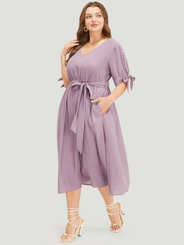 Plain Pearl Beaded Knotted Sleeve Pocket Belted Ruffle Dress sold by Bloomchic