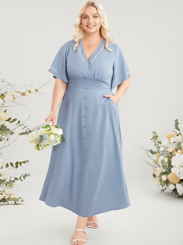 Solid Wrap Button Detail Pocket Ruffles Embroidered Dress sold by Bloomchic