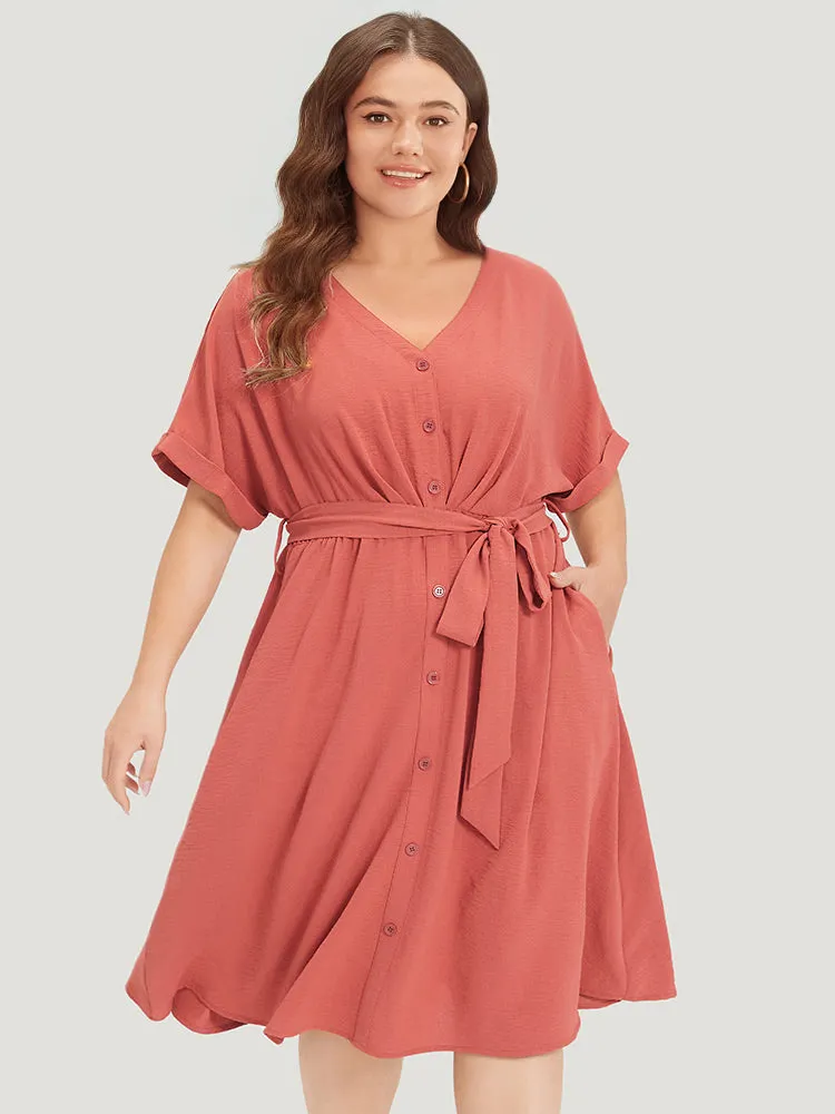 Solid Pocket Button Detail Ties Roll Sleeve Dress sold by Bloomchic