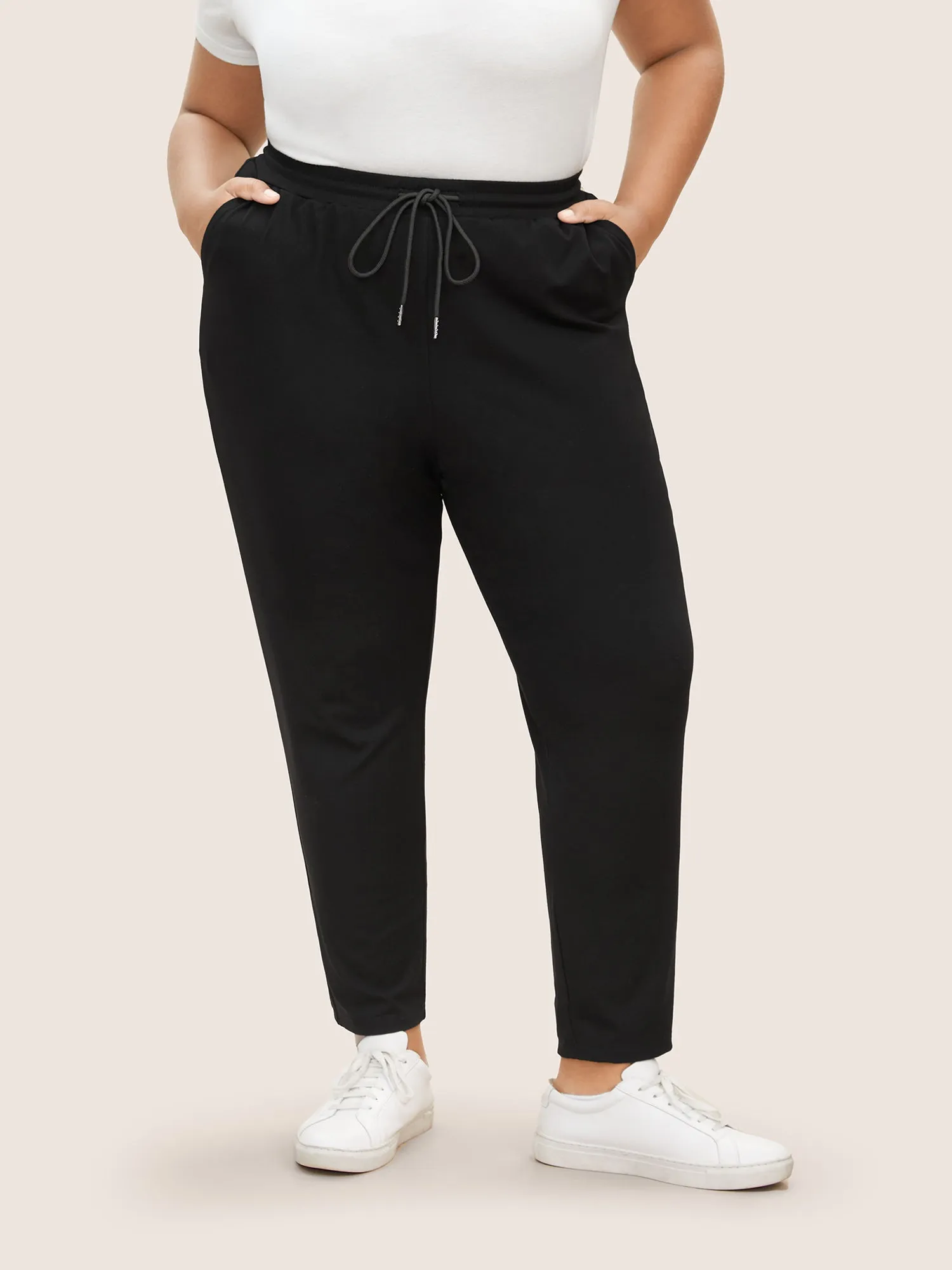 Plain Drawstring Waist Tapered Pants sold by Bloomchic