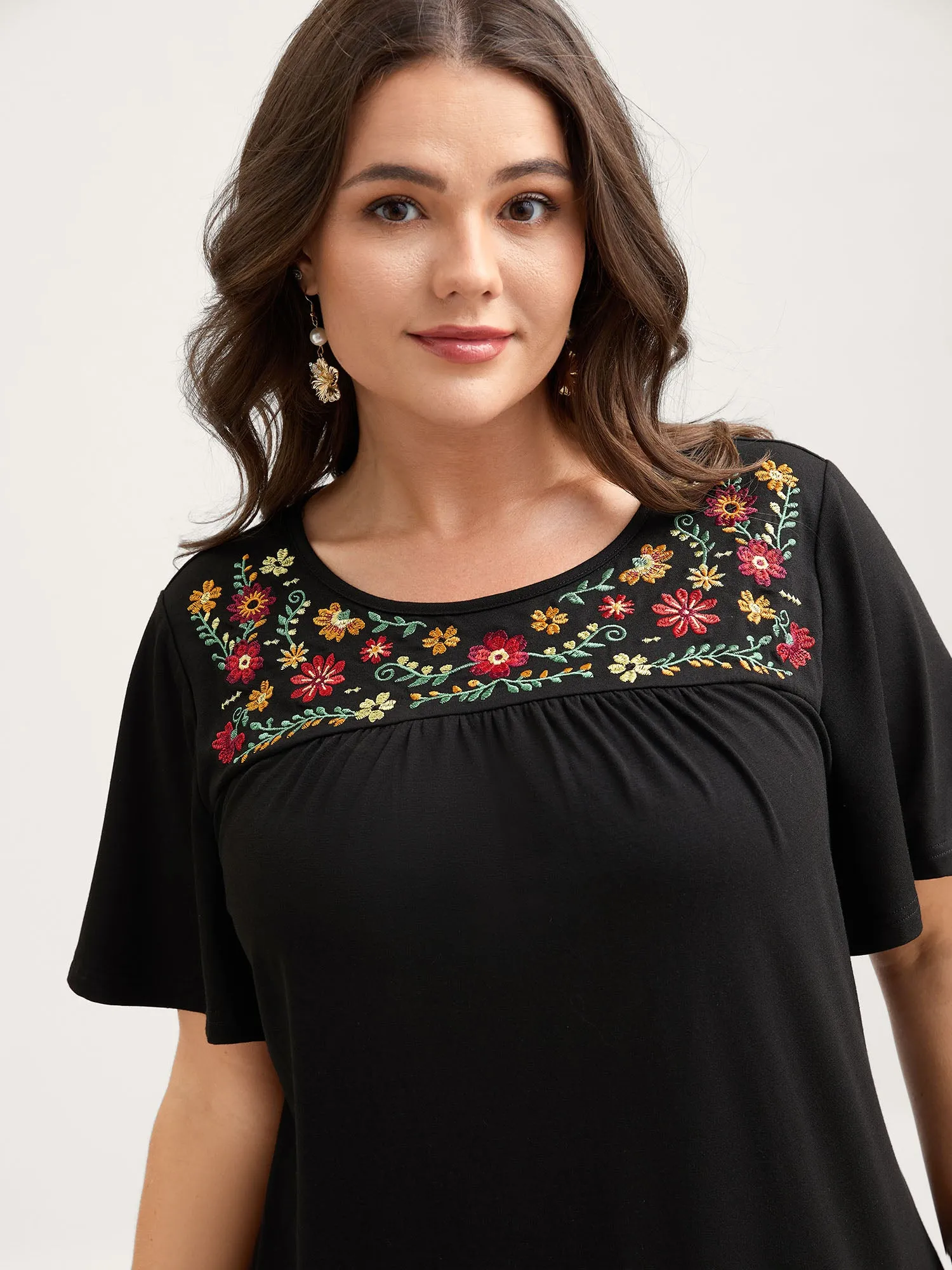 Stretchy Floral Embroidery Ruffled Hem Top sold by Bloomchic