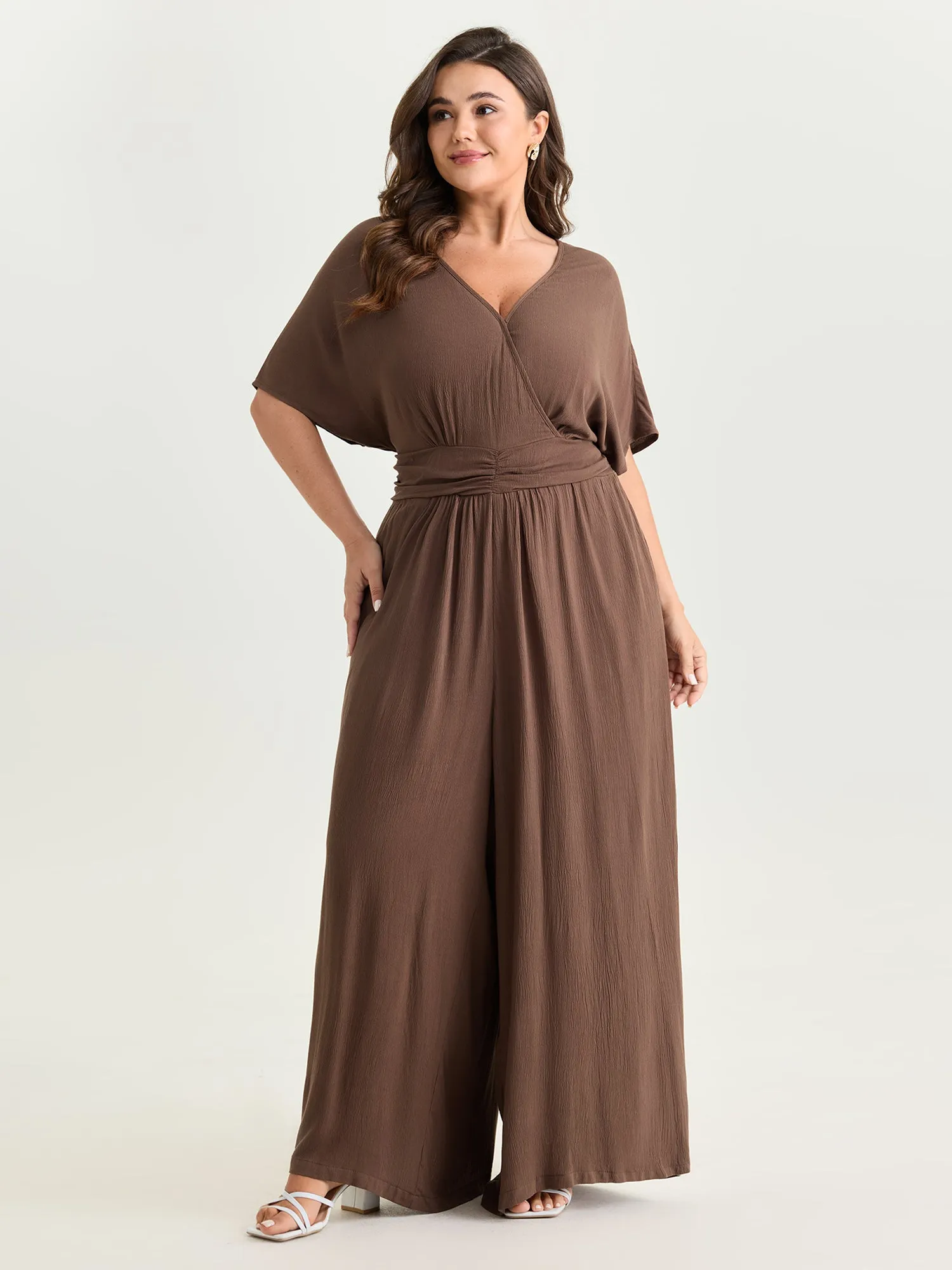 Textured Pleated Waist Surplice Jumpsuit sold by Bloomchic