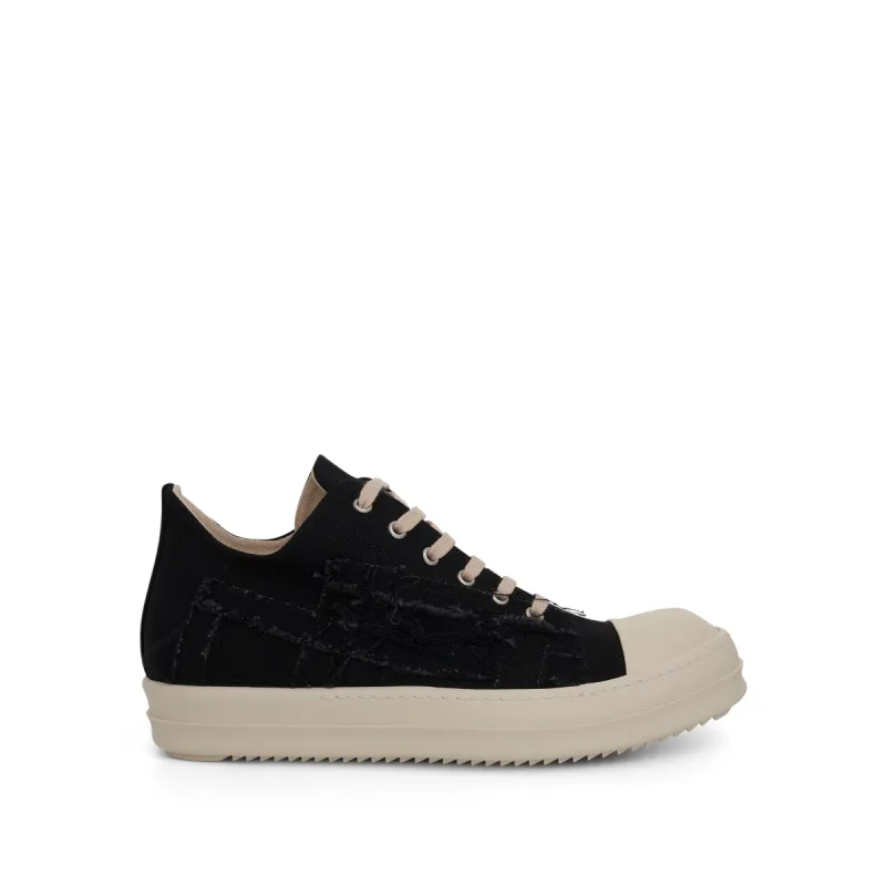 DRKSHDW Slashed Low Denim Sneakers in Black/Milk sold by MARAIS