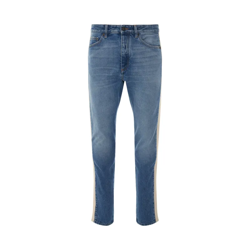 Indigo Track Denim Pants in Light Blue/White sold by MARAIS
