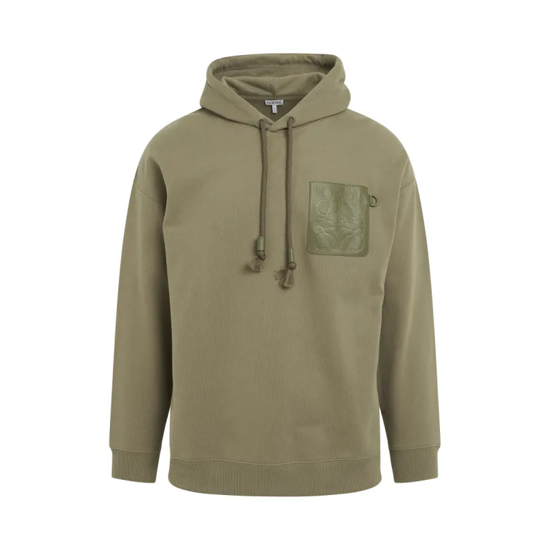 Anagram Patch Pocket Hoodie in Military Green sold by MARAIS