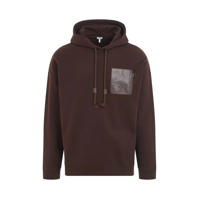 Anagram Patch Pocket Hoodie in Chocolate Brown sold by MARAIS