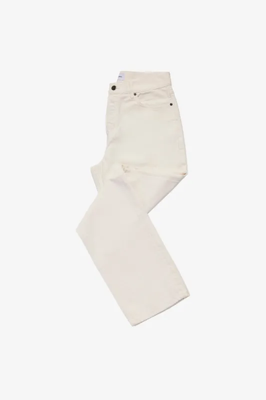 Five pocket denim pant in off-white twill sold by Anthony Squires