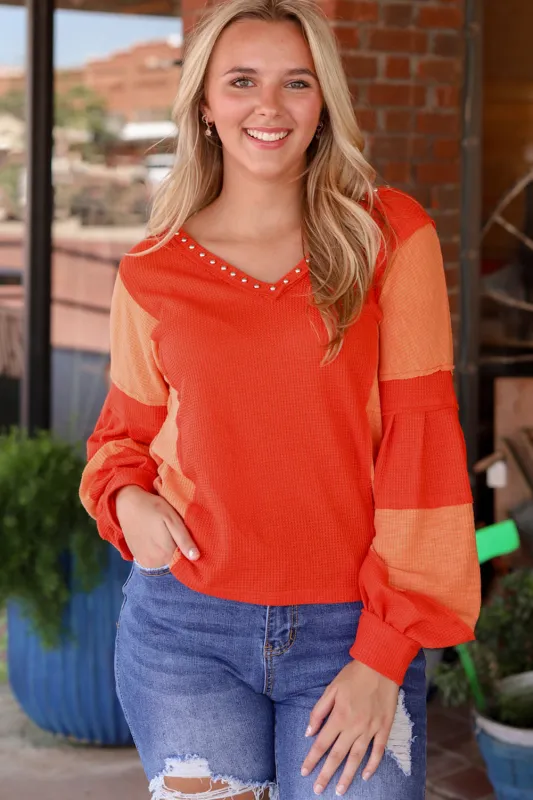 Fiery Red Studded V Neckline Exposed Seam Textured Knit Top sold by Beagle Boutique