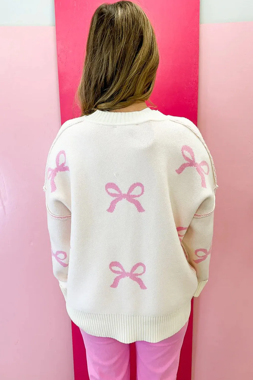 Pink Bow Print Ribbed Trim Exposed Seam Drop Shoulder Loose Sweater sold by Beagle Boutique product image thumbnail 2