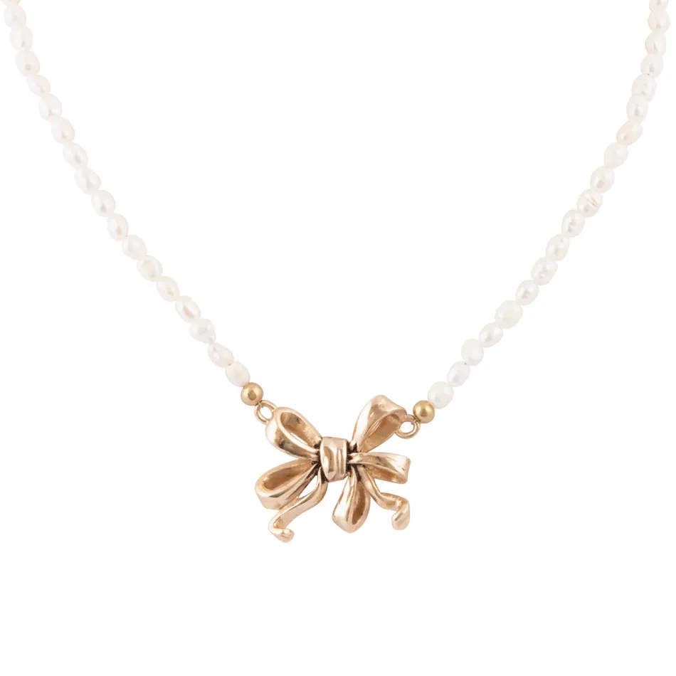 Gifted Freshwater White Pearl Golden Bow Pendant Necklace sold by Barse