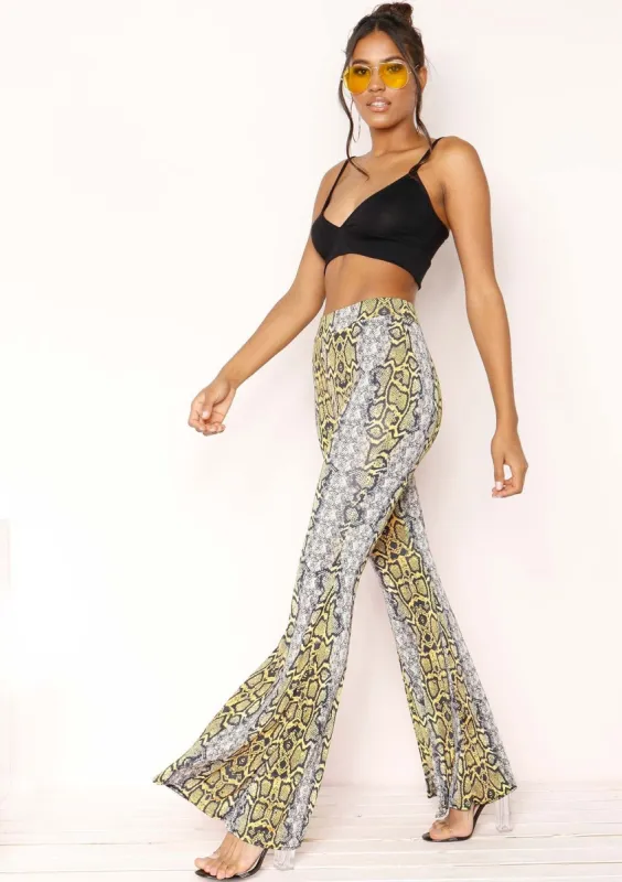 Jessy Yellow Snake Print Flare Trousers sold by Missy Empire