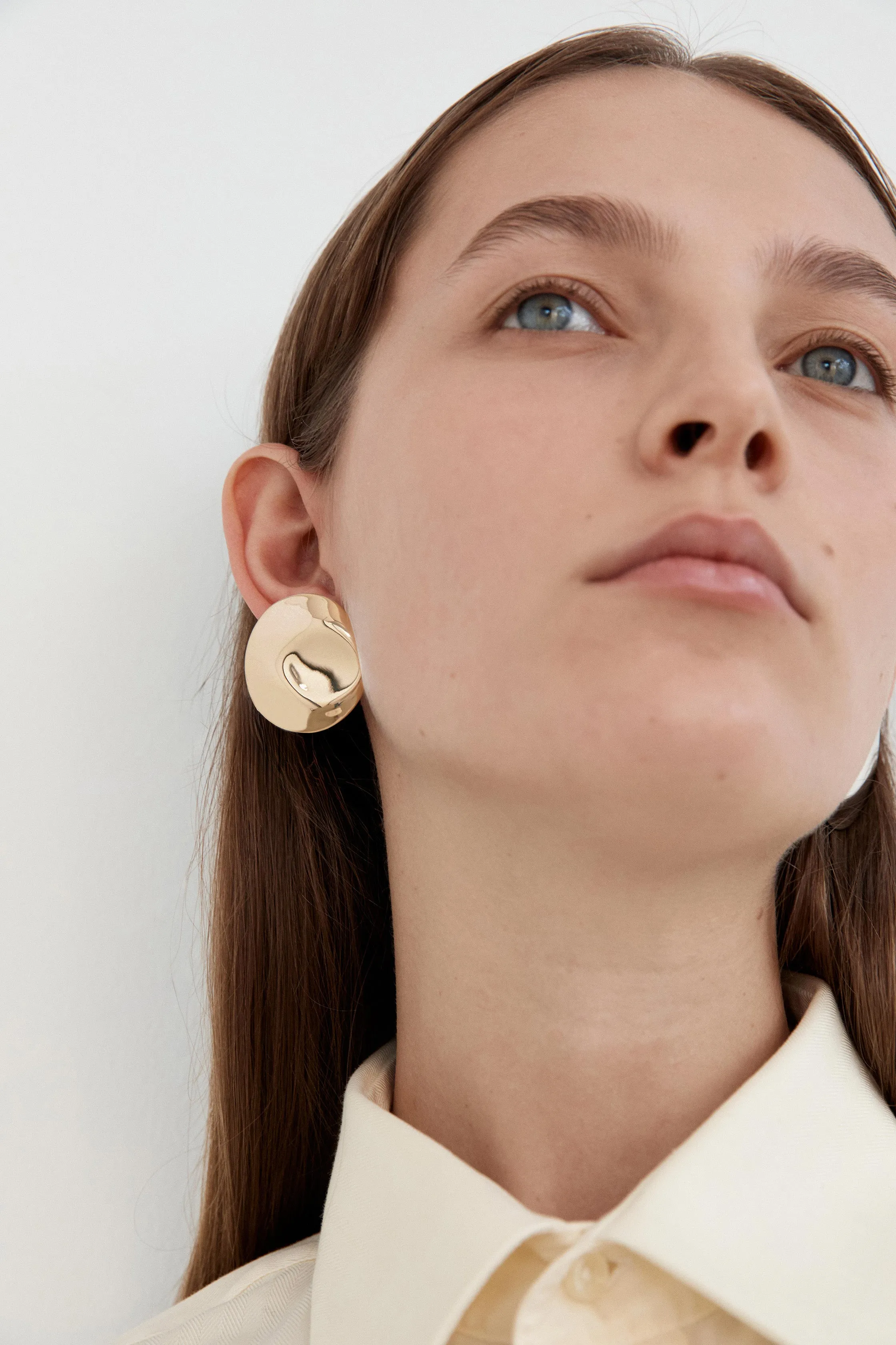 Dented Medallion Earrings - Gold sold by Nina Gordon