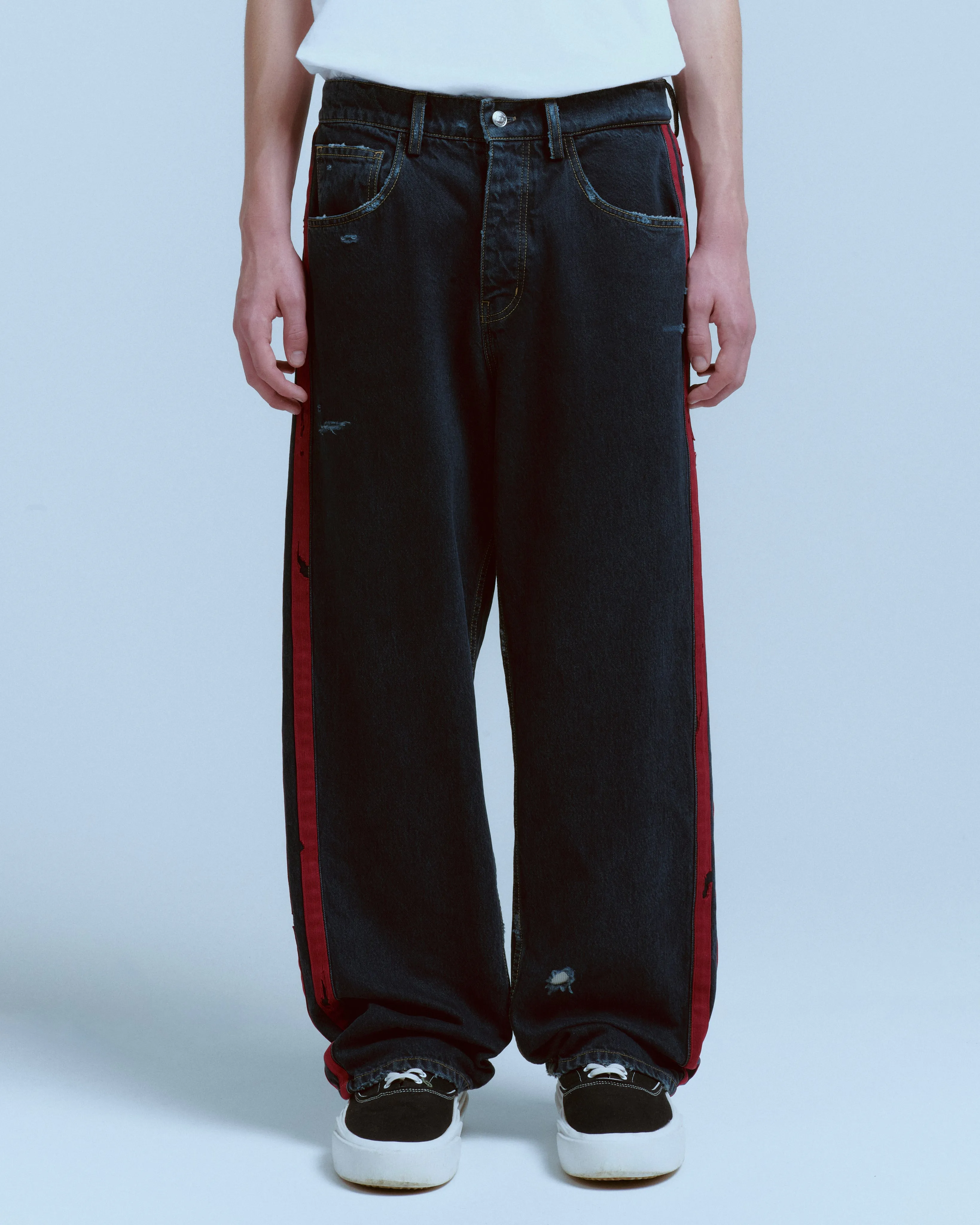 DESTROYED DENIM TRACK PANT sold by Nahmias
