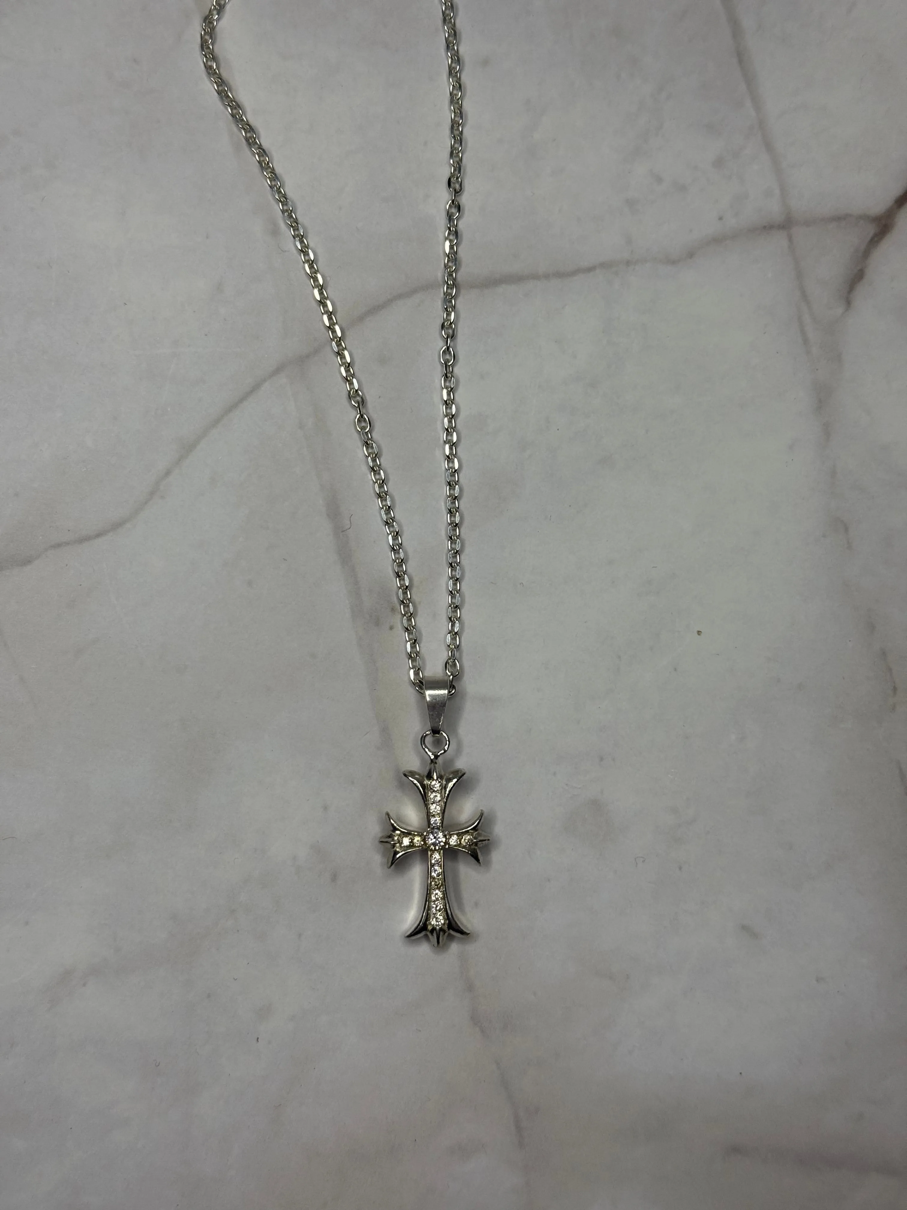 Chrome Cross Chain sold by Mary Louis