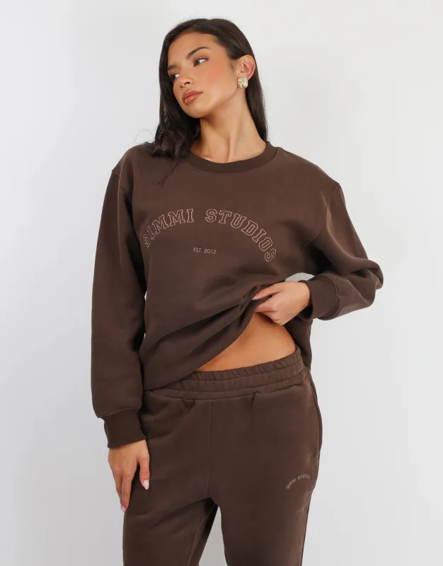 Ashby Simmi Studios Varsity Slogan Sweatshirt in Brown sold by Simmi London