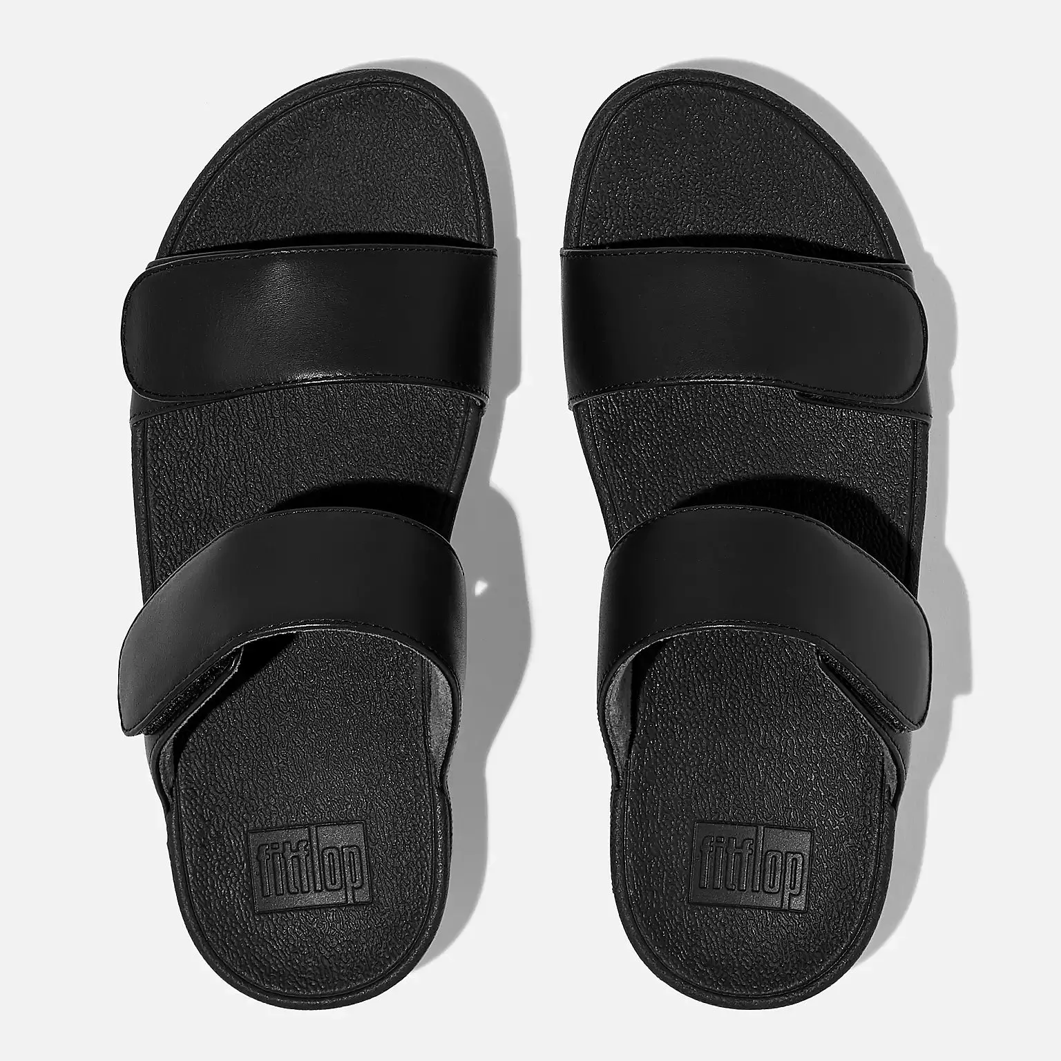 FitFlop Women's Lulu Adjustable Leather Slides All Black sold by Orleans Shoe Co.