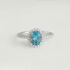 Oval Swiss Blue Topaz Halo Ring White Gold - Suna sold by Linjer