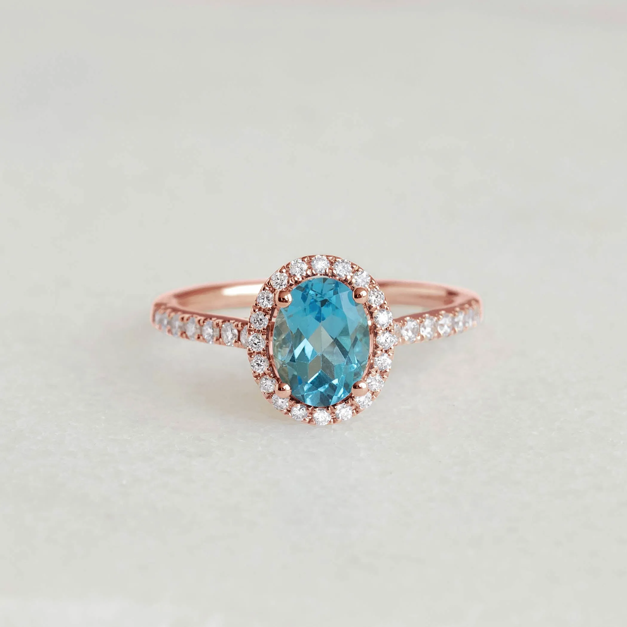 Oval Swiss Blue Topaz Halo Ring Rose Gold - Suna sold by Linjer