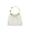 Cream Ring Handle Bag sold by VERAFIED