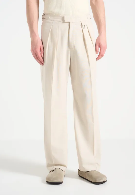 Pierre - Relaxed Fit Linen Pleated Tailored Trousers - Natural sold by Maniere De Voir