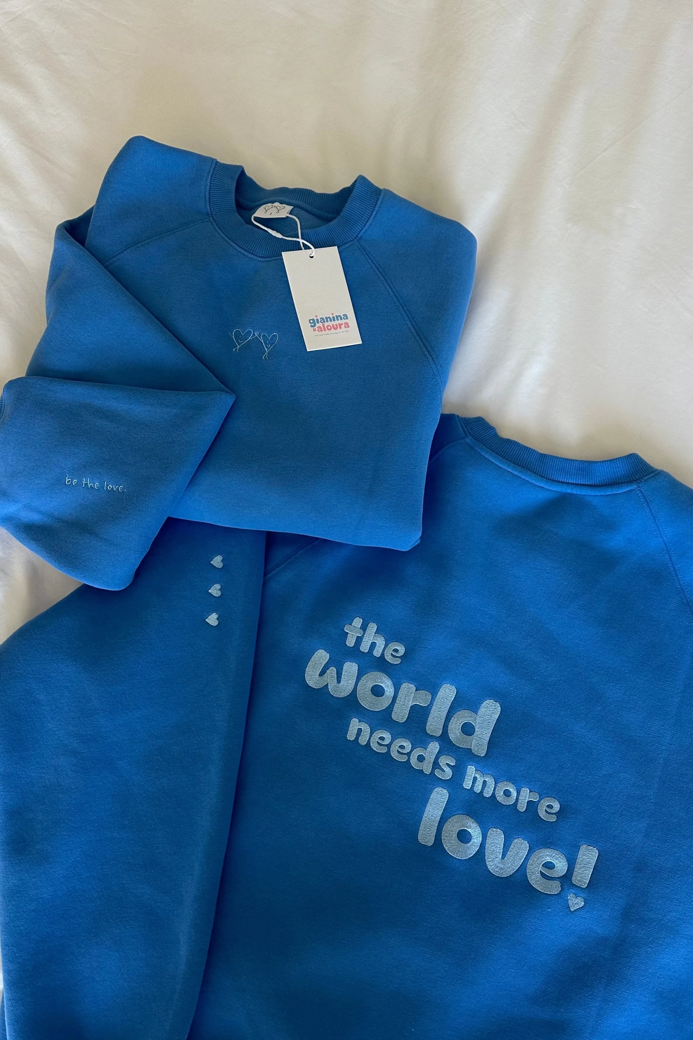 breezy blue "the world needs more love" ultra cozy crewneck sold by Aloura Lounge product image thumbnail 2