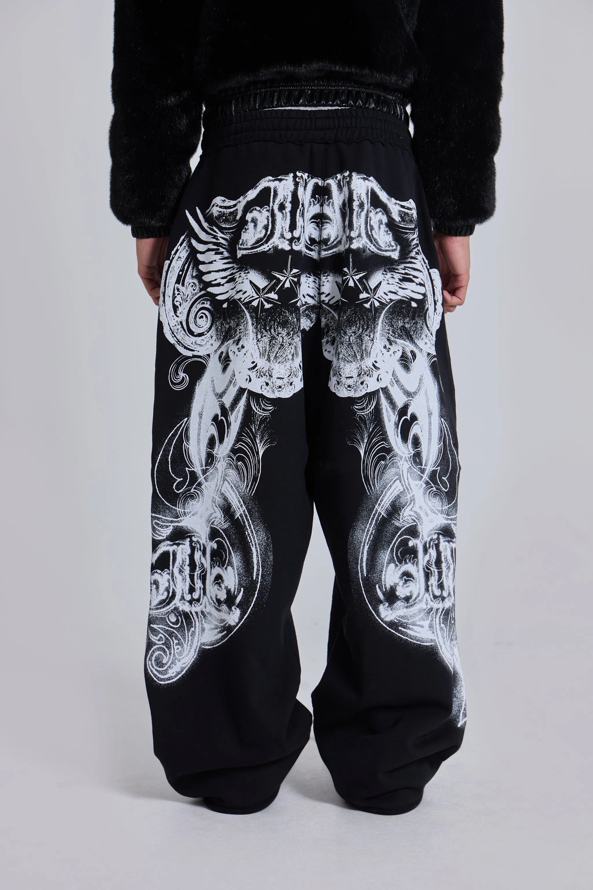 Black Gothic Print Baggy Monster Joggers sold by Jaded London
