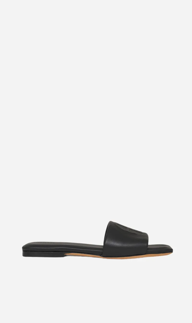 Anine Bing | Ria Slides Monogram - Black sold by Sister & Co