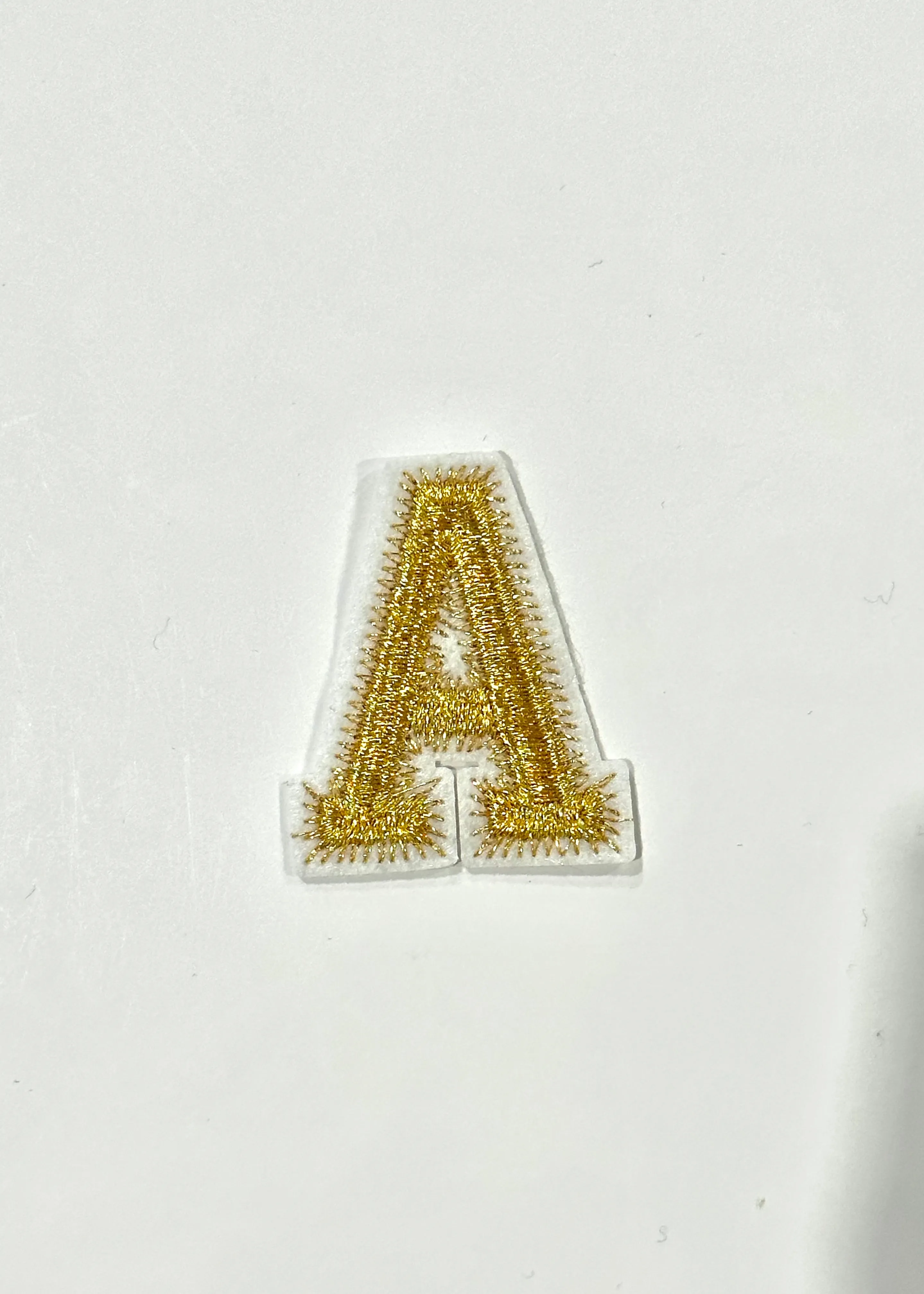 Gold Letter Zig Zag Stitch Patch sold by Bella Chic