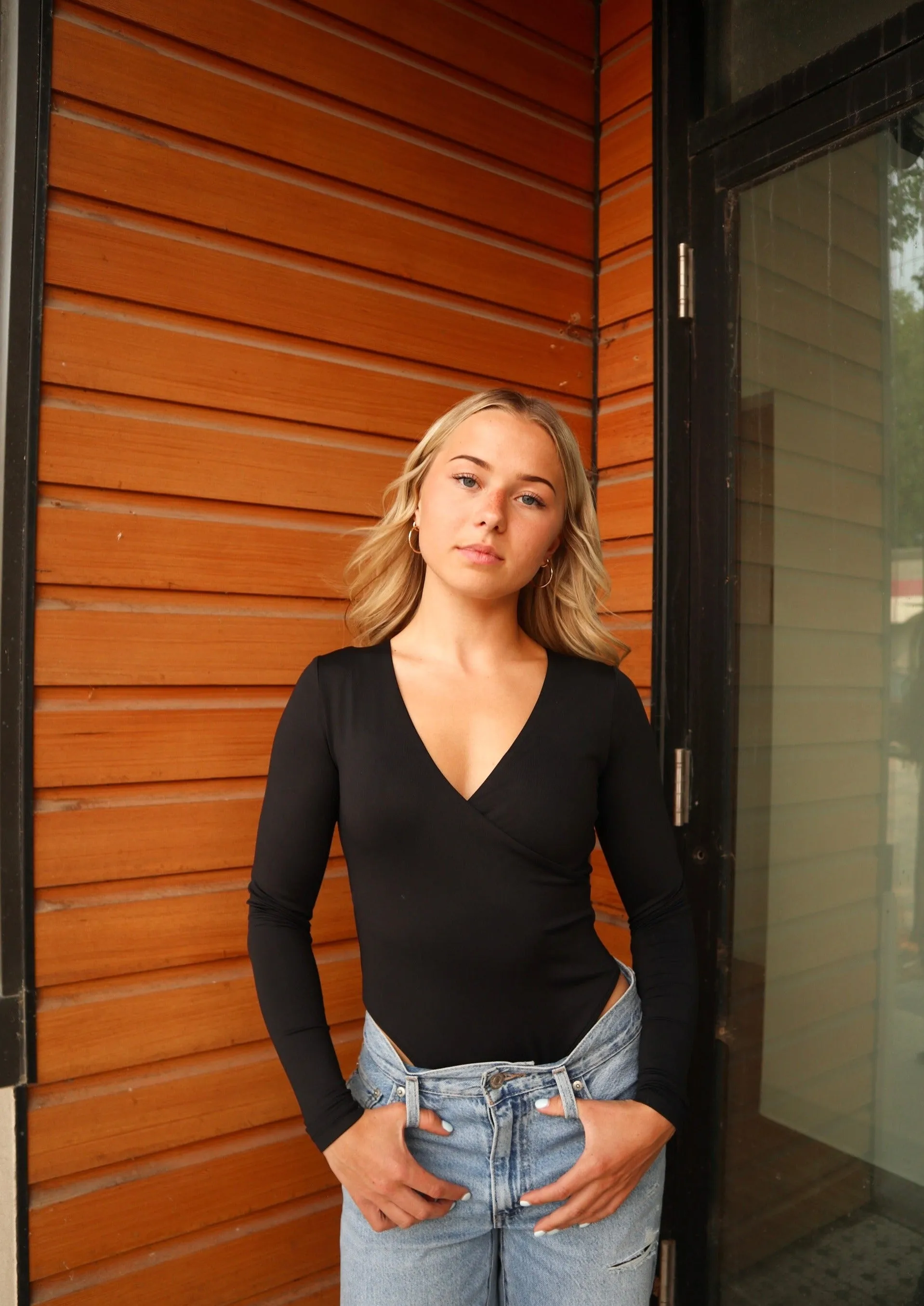 Elodie Wrap Longsleeve Bodysuit | Black sold by Bella Chic