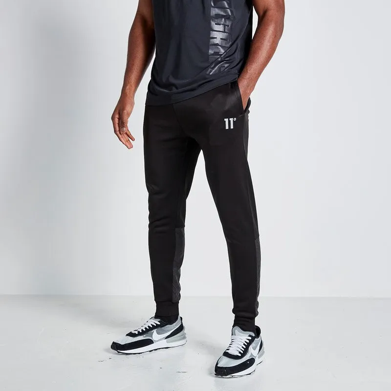 Joggers Con Paneles Estampados - Negro sold by Eleven degrees