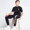 Joggers De Corte y Confección Con Panel De Texto Niño - Negro sold by Eleven degrees