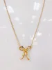 Ribbon Bow Pendant Necklace sold by Mimosa