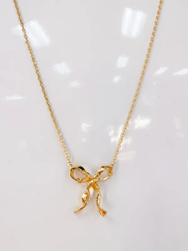 Ribbon Bow Pendant Necklace sold by Mimosa