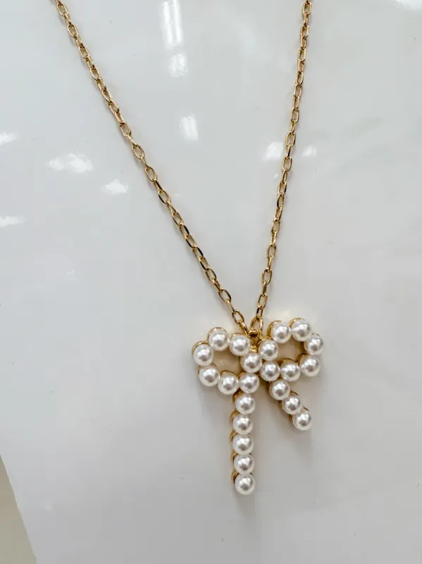 Pearl Ribbon Bow Pendant Necklace sold by Mimosa