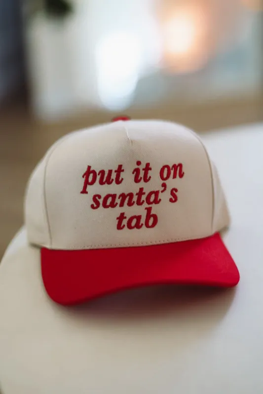 Put It On Santa's Tab Embroidered Trucker Hat -  Red and Cream sold by Hazel & Olive