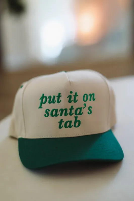 Put It On Santa's Tab Embroidered Trucker Hat -  Green and Cream sold by Hazel & Olive