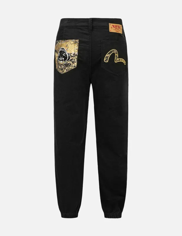 Godhead and Seagull Brocade Appliqué Straight Fit Woven Joggers sold by Evisu