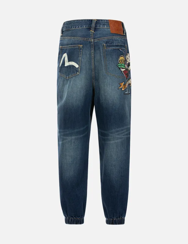 Playful Godhead Print Wide Leg Denim Joggers sold by Evisu