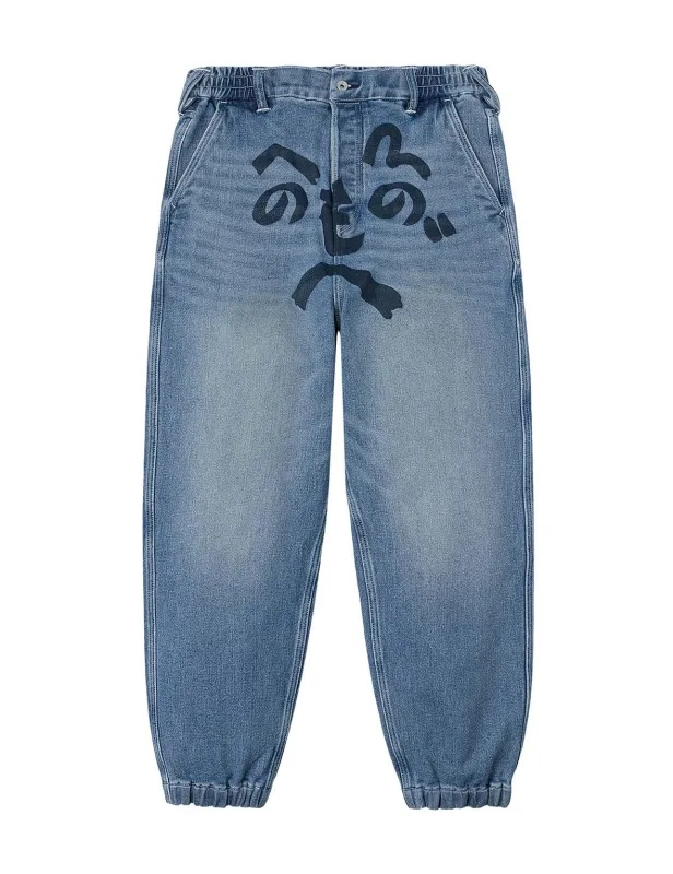 Henohenomohe Godhead Print Loose Fit Denim Joggers sold by Evisu