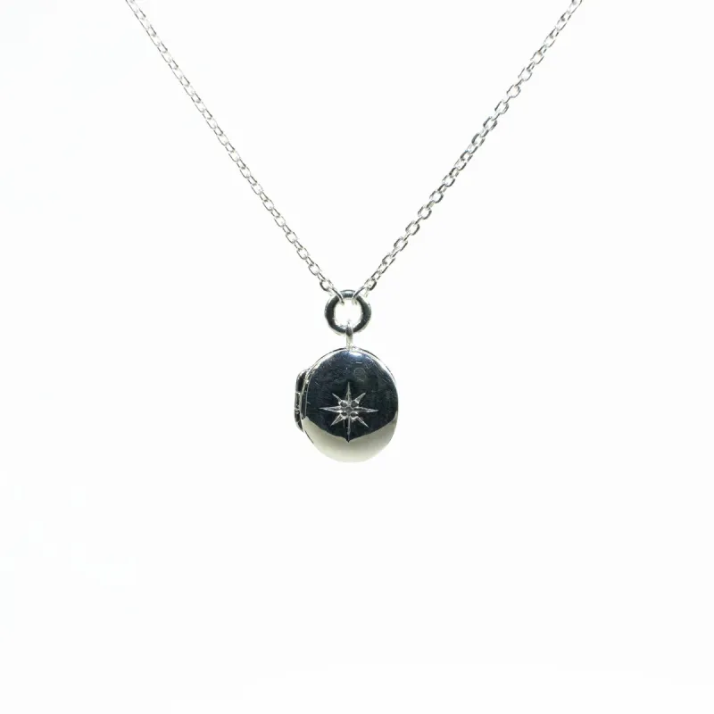 Oval Star-Set Silver Locket with White Sapphire sold by Silver Lotus