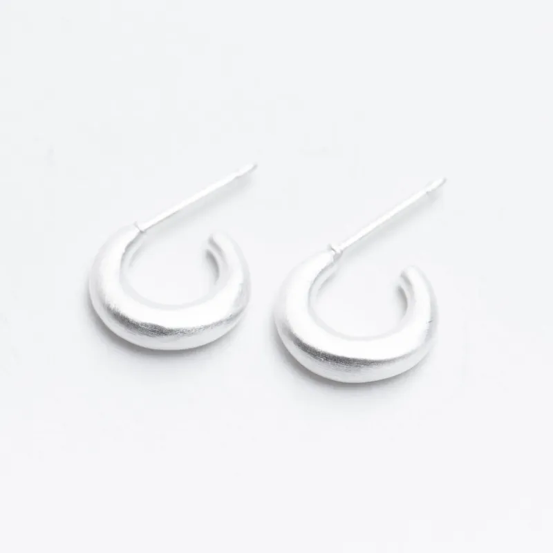 Silver Tiny Puffed Huggie Hoop on Post made by Silver Lotus