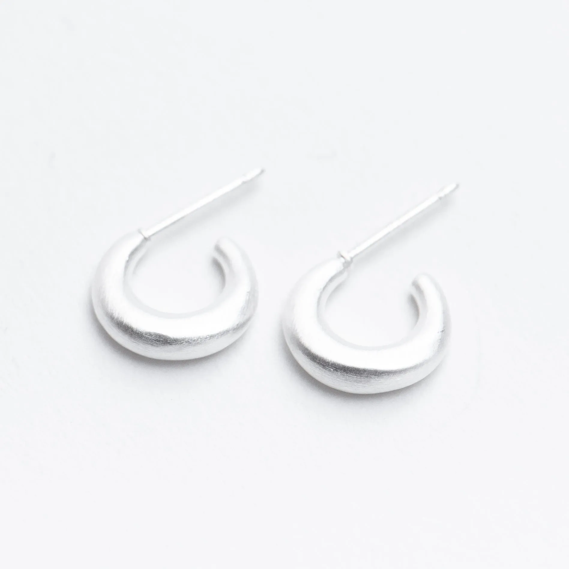 Silver Tiny Puffed Huggie Hoop on Post sold by Silver Lotus
