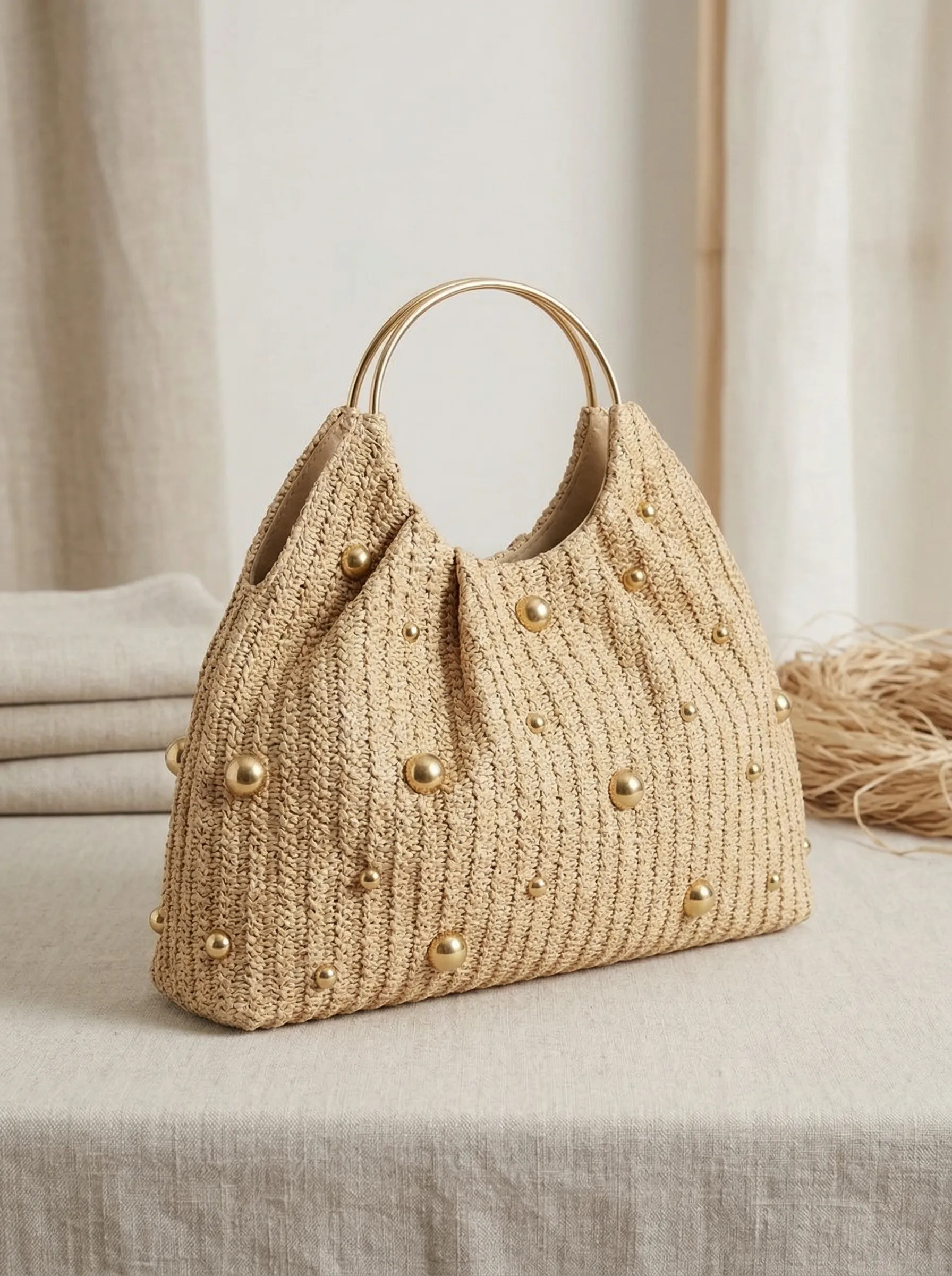 Artisanal Studded Handwoven Raffia Bag with Sculptural Gold Ring Handle sold by Lintico